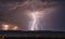 Lightning strikes on the horizon in the night sky