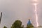 Lightning during a thunderstorm in the sky above the dome and cr