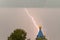 Lightning during a thunderstorm in the sky above the dome and cr