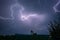 A lightningbolt creeps through the clouds over Transylvania, Romania