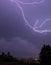 Lightnings over town during night with blue sky