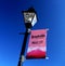 Lightpole with pink `Leadville Colorado Magic City` sign showing mountains at the bottom in white and pink shades