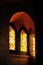 Lights across stained colored glass gothic window