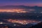 Lights of the city of Denizli at the foot of the Taurus mountains burn like constellations and nebulae in the night sky.