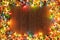 Lights decoration. Wooden background with christmas multi-colored lights garland. In frame with copy space for a text