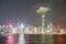 Lights of Hong Kong commercial skyline reflected on calm water o