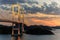 Lights from Kurushima Bridge mix with sunset glow over islands in Seto Inland Sea