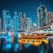 Lights of the night city in the Dubai Marina district. Stylized ancient Arabic ship Abra Dhow with lights in the