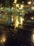 The lights of the night city through the wet glass. Abstract view.