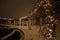 Lights, Snow, and Vines Cover a Large Trellis at Night