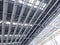 Lights and ventilation system in long line on ceiling of the industrial building. Exhibition Hall. Ceiling factory construction
