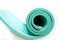 Lightweight foam green roll. Yoga mat as swirle on isolated white. Concept