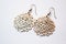 Lightweight Lasercut Metal Earrings N Intricate Lacelike Pattern White Background. Generative AI