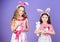 Like bunny rabbits. Cute children in Easter bunny style holding hearts. Small children in Easter bunny headbands. Little