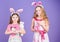Like bunny rabbits. Cute children in Easter bunny style holding hearts. Small children in Easter bunny headbands. Little