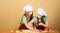 They like cooking. Adorable little girls enjoy cooking together. Small children taking cooking class. Cute cooks in