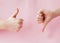 Like hand sign on a light trending pink background, Successful concept, female hand thumb up