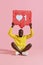 Like. Happy black man holding like heart icon pinata on pink