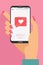 Like mobile mobile concept. Female hand holding smartphone with heart emoji message on screen, like button. Love confession, like