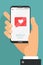 Like mobile mobile concept. Male hand holding smartphone with heart emoji message on screen, like button. Love confession, like.