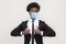 Like. Portrait of satisfied funny young hamdsome worker man in black suit with surgical medical mask standing, thumbs up and