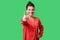 Like! Portrait of satisfied positive young woman with bun hairstyle showing thumbs up gesture. isolated on green background