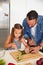 Like a pro chef already. Shot of an adorable little girl cooking with her father at home.