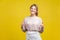 Like, thumbs up! Portrait of excited beautiful woman with fair hair in casual beige blouse, isolated on yellow background