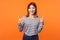 Like, thumbs up! Portrait of joyful kind young woman with brown hair in long sleeve striped shirt. isolated on orange background