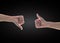 Like - unlike hand with thumb up - down symbolic people gesture isolated on black background with clipping path
