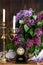 Lilac bouquet in ceramic jug, lilac brush and forging candle holder with candles. Still life