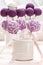 Lilac cake pops lavishly decorated with icing.