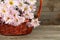 Lilac chrysanthemums in basket on wooden background