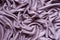 Lilac colored viscose fabric in soft folds