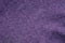 Lilac dark background from a fragment of crumpled fabric