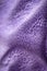 Lilac delicate soft background of fur plush smooth fabric. Texture of purple soft fleecy blanket textile