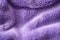 Lilac delicate soft background of fur plush smooth fabric. Texture of purple soft fleecy blanket textile