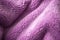 Lilac delicate soft background of fur plush smooth fabric. Texture of purple soft fleecy blanket textile