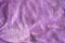 Lilac delicate soft background of fur plush smooth fabric. Texture of purple soft fleecy blanket textile