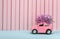 Lilac flower on cartoon toy car with empty space