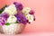 Lilac flowers bunch in a basket on blurred coral pink backgrond. Beautful fragrant Lilac Flowers bouquet with Copy space