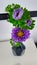 Lilac flowers in a class vase on a white table