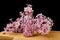 Lilac flowers and essential oil in a glass vessel. Ecological preparations on a wooden board