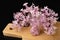 Lilac flowers and essential oil in a glass vessel. Ecological preparations on a wooden board