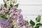Lilac flowers on the horizontal wooden background