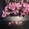 Lilac flowers in openwork vase with water drops closeup