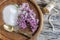 Lilac flowers and sugar on a wooden board