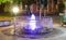 Lilac fountain in the center of the old part of the night Pomorie in Bulgaria