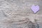 Lilac heart on a wooden surface. The wooden background with heart.