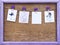 Lilac hearts and blank note on the clothespin on old wooden background in wooden photo frame